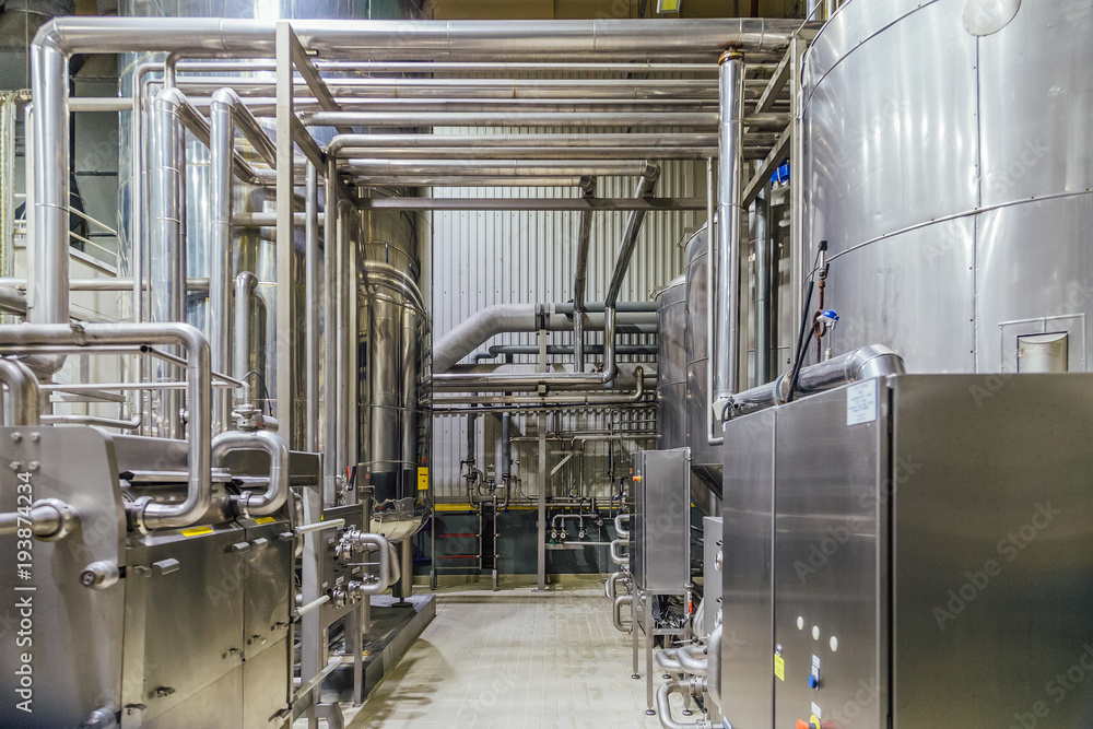 Modern brewery interior. Filtration vats, pipeline, valves and other equipment of beer production line Modern brewery interior. Filtration vats, pipeline, valves and other equipment of beer production line