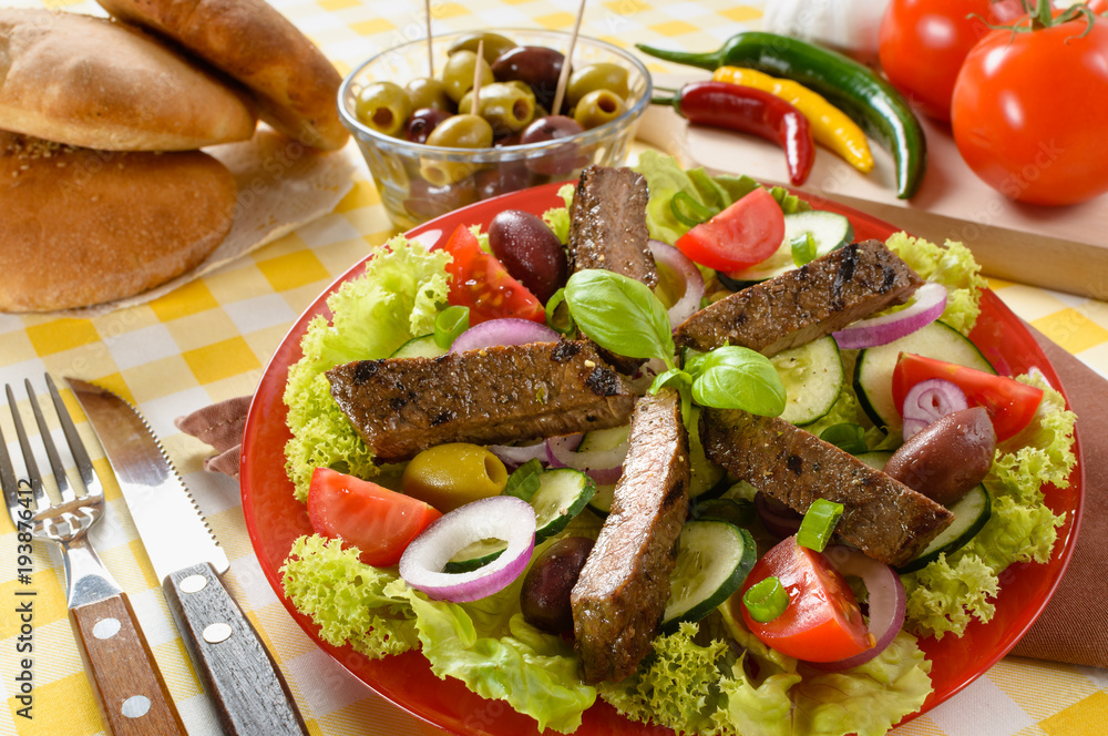 Beef salad on the plate. Grilled beef meat with tasty selection of vegetables. Beef salad on the plate. Grilled beef meat with tasty selection of vegetables.