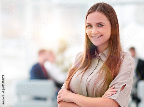 portrait of smiling business woman on the background of the office.