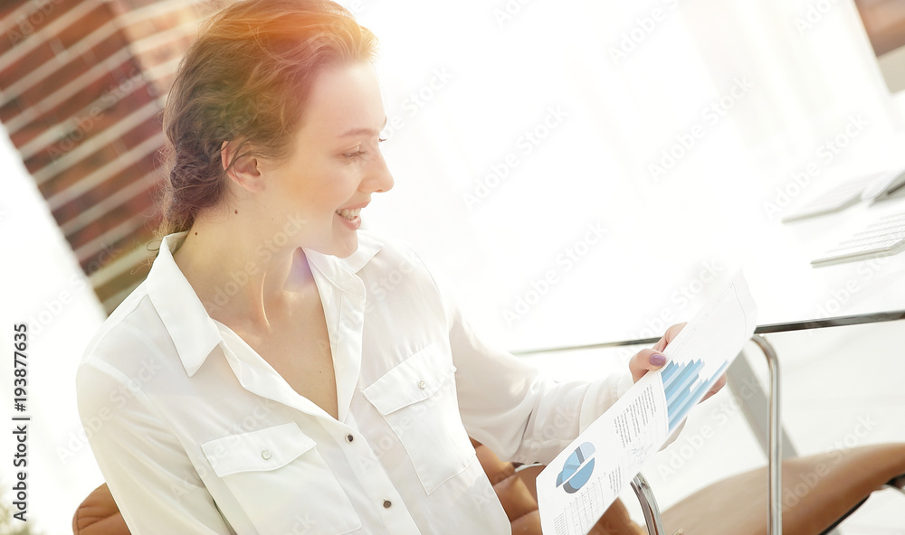 young business woman is reading a working paper. young business woman is reading a working paper.