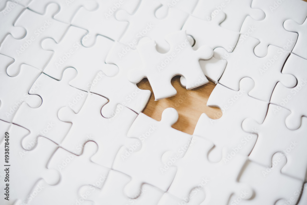 close up of puzzle pieces on table, business and connection concept close up of puzzle pieces on table, business and connection concept