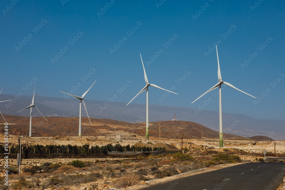 electric wind turbines farm, blue sky background electric wind turbines farm, blue sky background