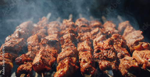 Obraz na plátně grilled barbecue meat on skewers with smoke