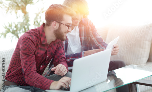 Photography Portrait of two web designers discussing a project in front of a laptop