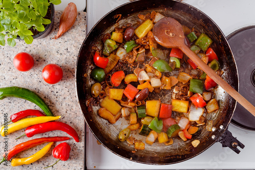 Mix of fresh vegetables fried in the rustic pan, fresh hot chili peppers, tomato and herbs.