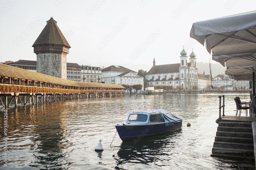 Fototapeta premium View of the famous bridge Kapellbruecke (wooden chapel) in the evening in Lucerne