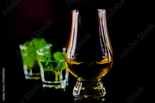 single malt whiskey in a glass and green mint liqueur, refreshing set of drinks