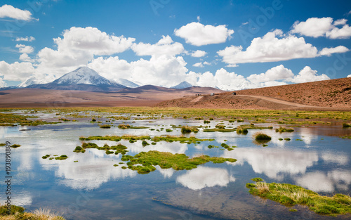 Andes region, Bolivia with snow covered volcano and flooded flields photo