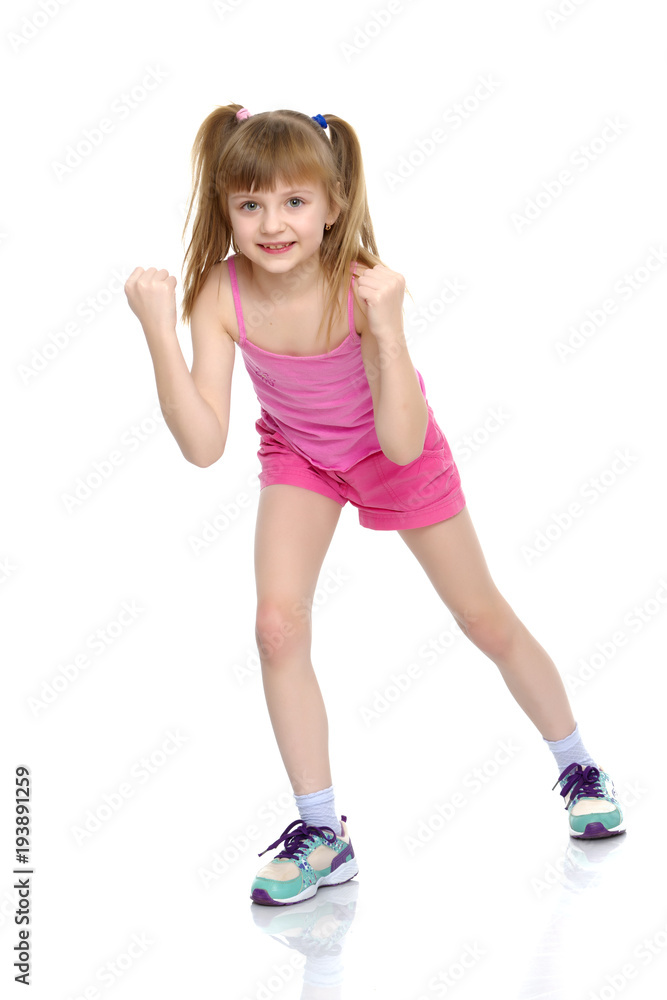 A little girl shows her muscles. A little girl shows her muscles.