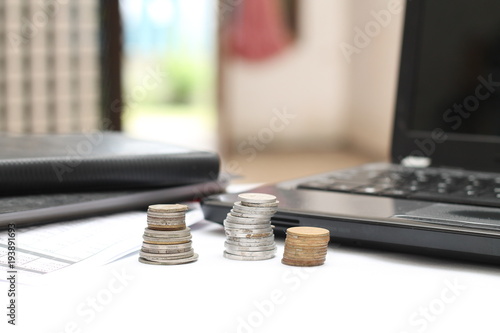 coins on the table, with laptops and financial reports.