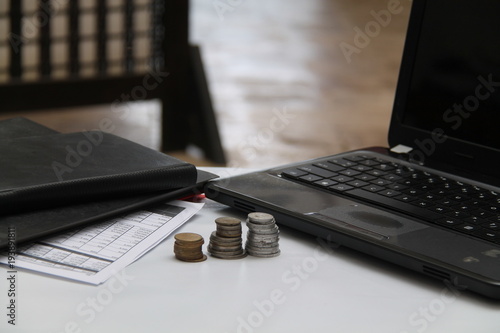 coins on the table, with laptops and financial reports.