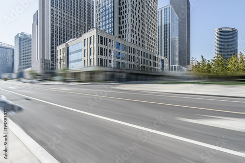 blurred asphalt road front of modern buildings