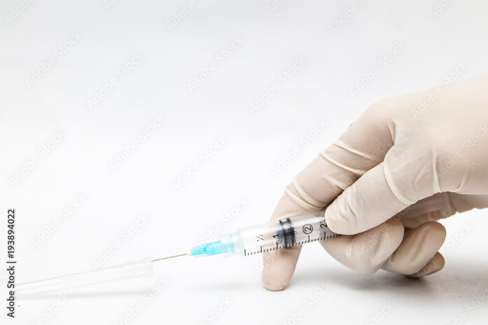 holding a injection syringe 3 cc with hand glove (one hand technique). holding a injection syringe 3 cc with hand glove (one hand technique).