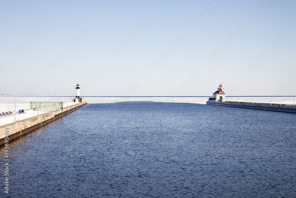 Open shipping channel with lighthouses on frozen Lake Superior, Duluth, Minnesota