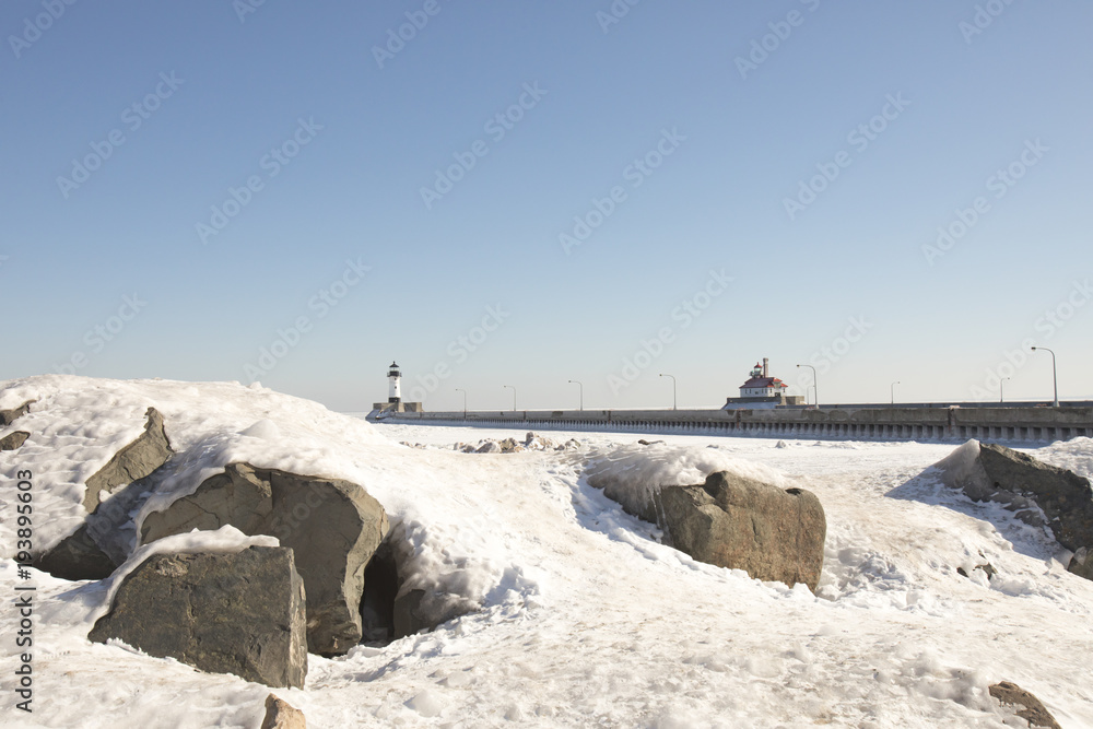Lighthouses on frozen Lake Superior waterfront, Duluth, Minnesota in winter  on frozen rocky shores of Lake Superior waterfront, Duluth, Minnesota in winter