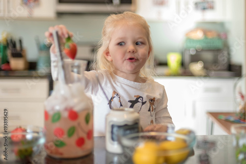Little girl making lemonade