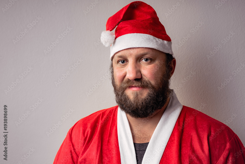 Bearded Santa Claus man with a long beard in Christmas or Xmas sweater and new year hat. Bearded Santa Claus man with a long beard in Christmas or Xmas sweater and new year hat.