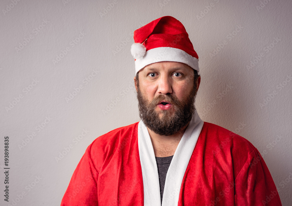 Bearded Santa Claus man with a long beard in Christmas or Xmas sweater and new year hat. Bearded Santa Claus man with a long beard in Christmas or Xmas sweater and new year hat.