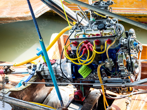 Rear side of long tail boat with dirty old engine at Khlong Lat Mayom Floating Market Bangkok, Thailand.