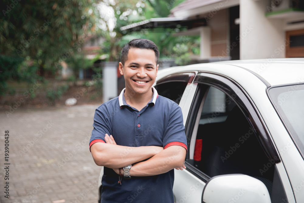 standing in front of car. male taxi driver standing in front of car. male taxi driver