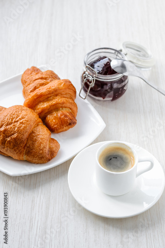 morning breakfast. Coffee, croissants and jam on white background