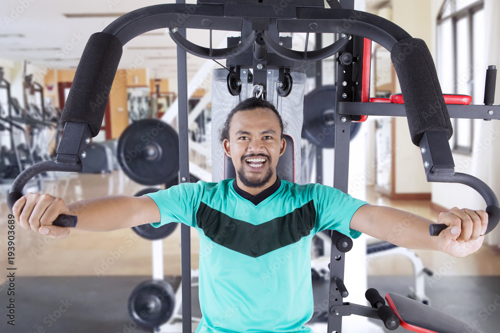 Happy asian man exercising in gym Happy asian man exercising in gym