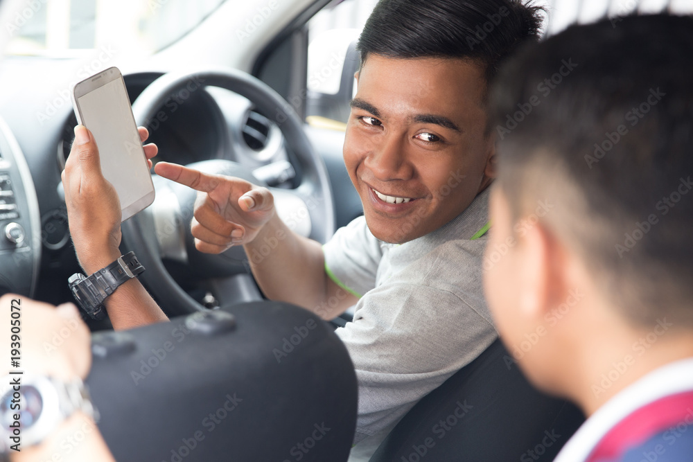 driver showing mobile phone to customer driver showing mobile phone to customer