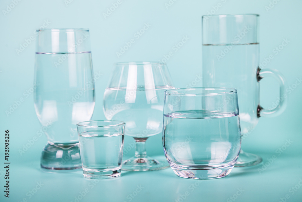 Transparent water in different glasses. Transparent water in different glasses.