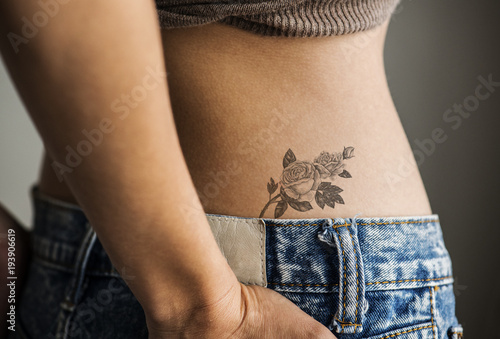 Obraz na plátne Closeup of lower hip tattoo of a woman