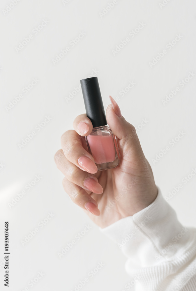 Closeup of hand holding nail polish bottle Closeup of hand holding nail polish bottle