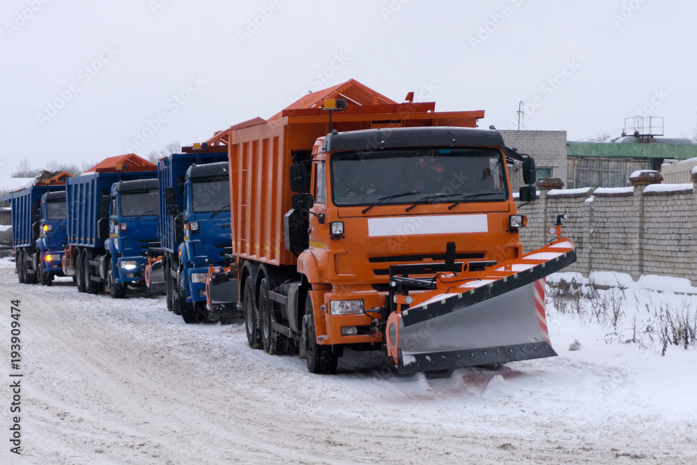 Snow Plows clearing a highway during a snow blizzard . Snow Plows clearing a highway during a snow blizzard .