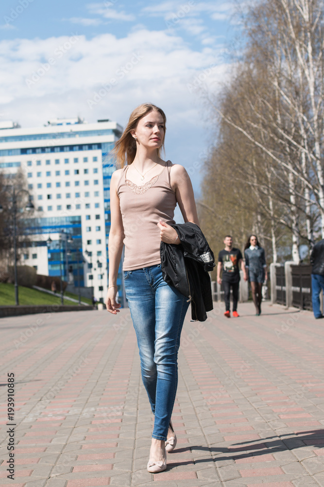 Girl with blond hair on the street of city