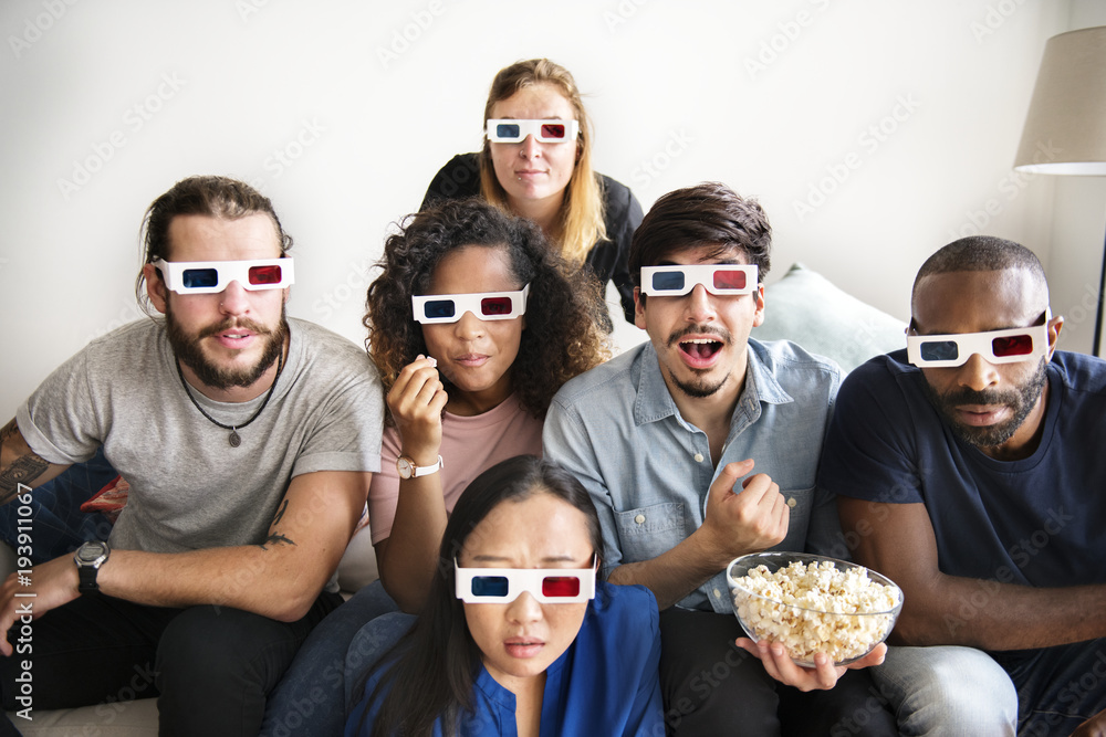 Obraz premium Group of diverse friends watching 3D movie together