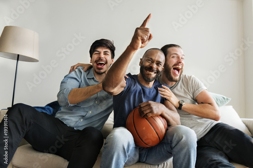 Friends cheering sport league together