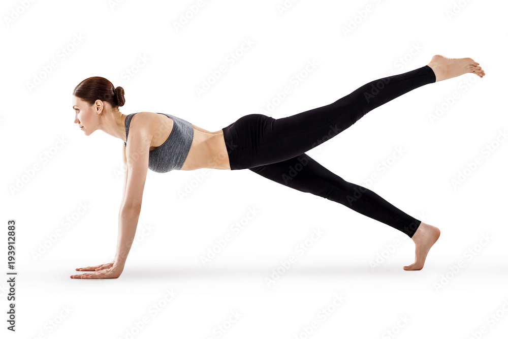 Attractive young woman practicing yoga.