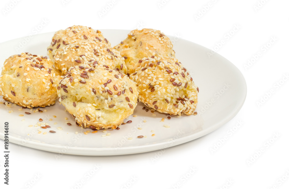 Savory profiteroles sprinkled with flax seeds and sesame seeds closeup Savory profiteroles sprinkled with flax seeds and sesame seeds closeup