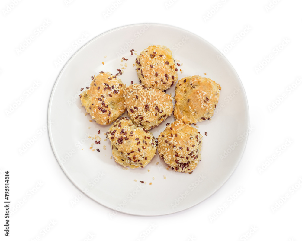 Savory profiteroles sprinkled with flax and sesame seeds on dish Savory profiteroles sprinkled with flax and sesame seeds on dish