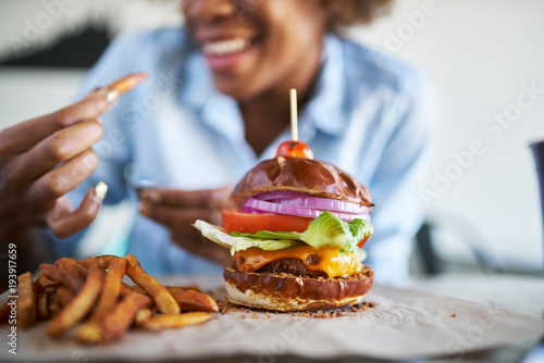african american woman with vegan meatless burger meal