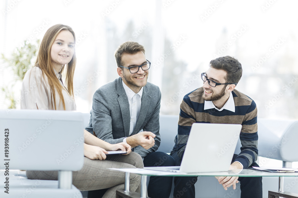 managers of the company and the client, discussing the terms of the new contract and look at the laptop screen with the correct information. managers of the company and the client, discussing the terms of the new contract and look at the laptop screen with the correct information.