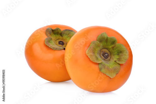 two whole ripe persimmons isolated on white background