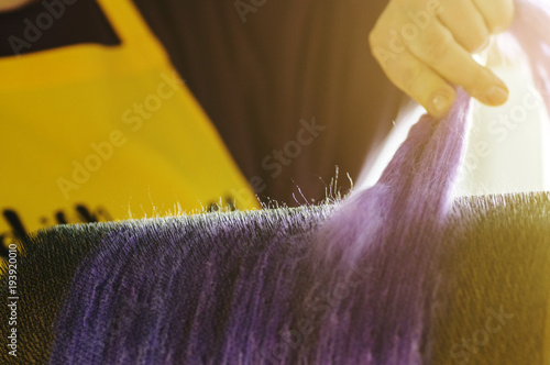 Felting wool. Combing the wool of alpaca or llama before felting on a special machine with a drum comb. photo