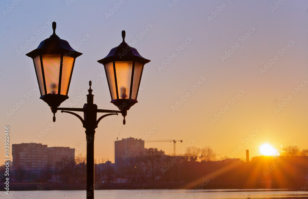 Street lamp at dawn. Street lighting in the sunset.