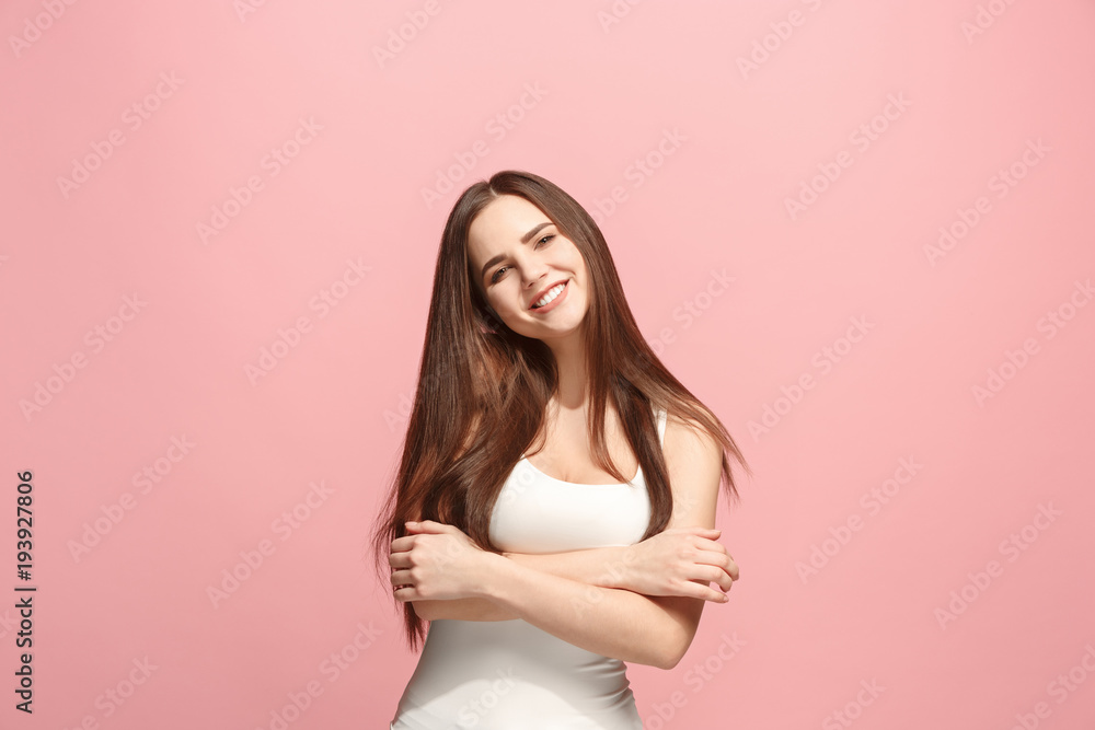 The happy business woman standing and smiling against pink background. The happy business woman standing and smiling against pink background.