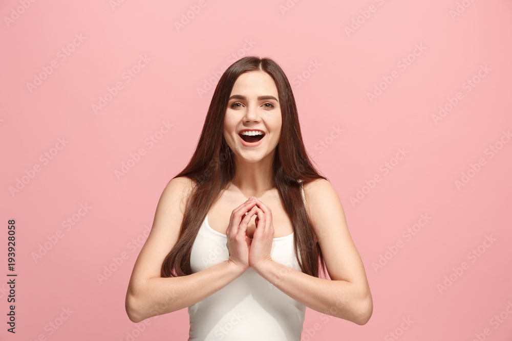 Obraz premium The happy business woman standing and smiling against pink background.