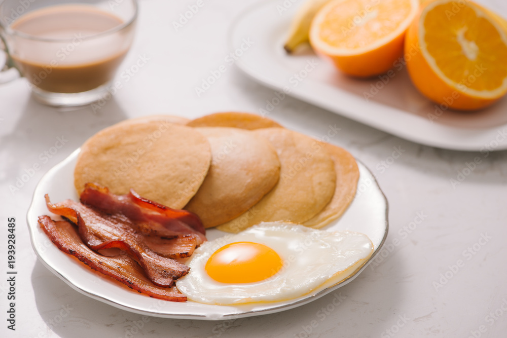 Breakfast plate with pancakes, eggs, bacon and fruit. Breakfast plate with pancakes, eggs, bacon and fruit.