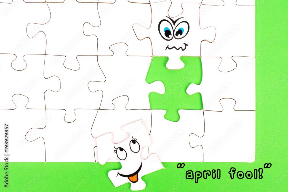 Puzzle pieces with a funny face and the words april fools Puzzle pieces with a funny face and the words april fools