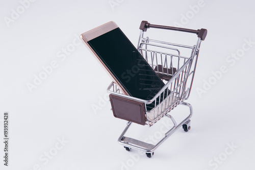 A shopping cart with smartphone inside, indicating mobile commerce and e-commerce