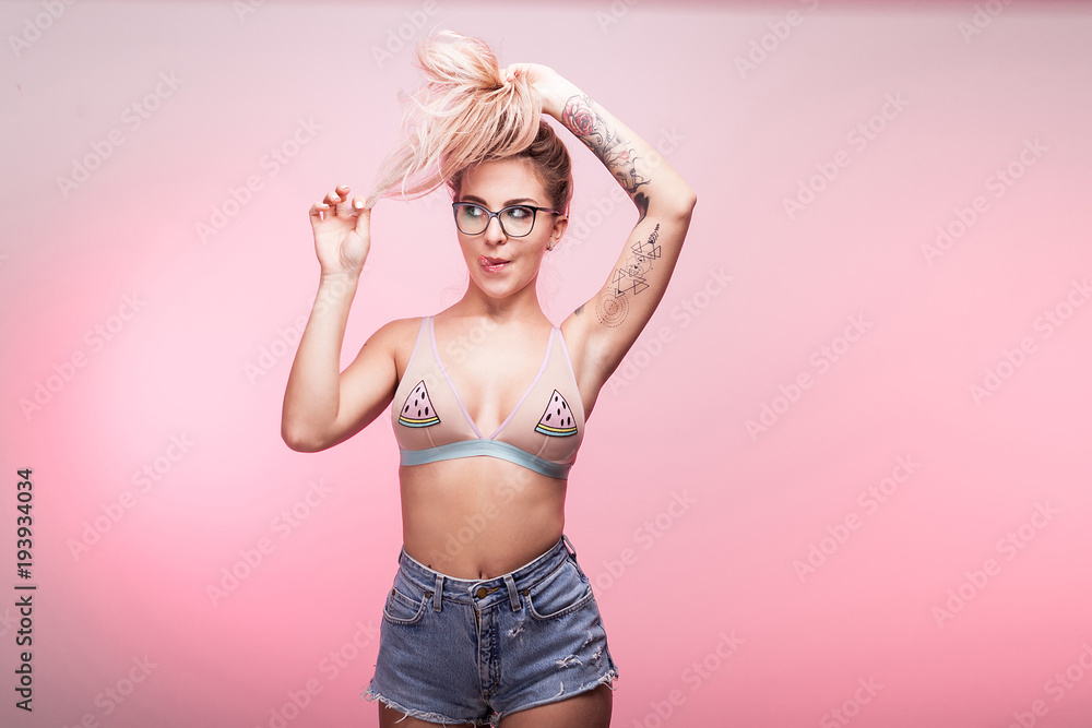Sexy woman playing with her hair on pink background Sexy woman playing with her hair on pink background