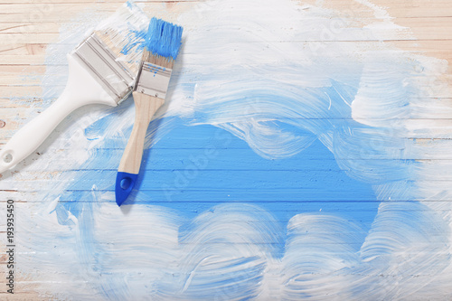brush with paint on wooden background
