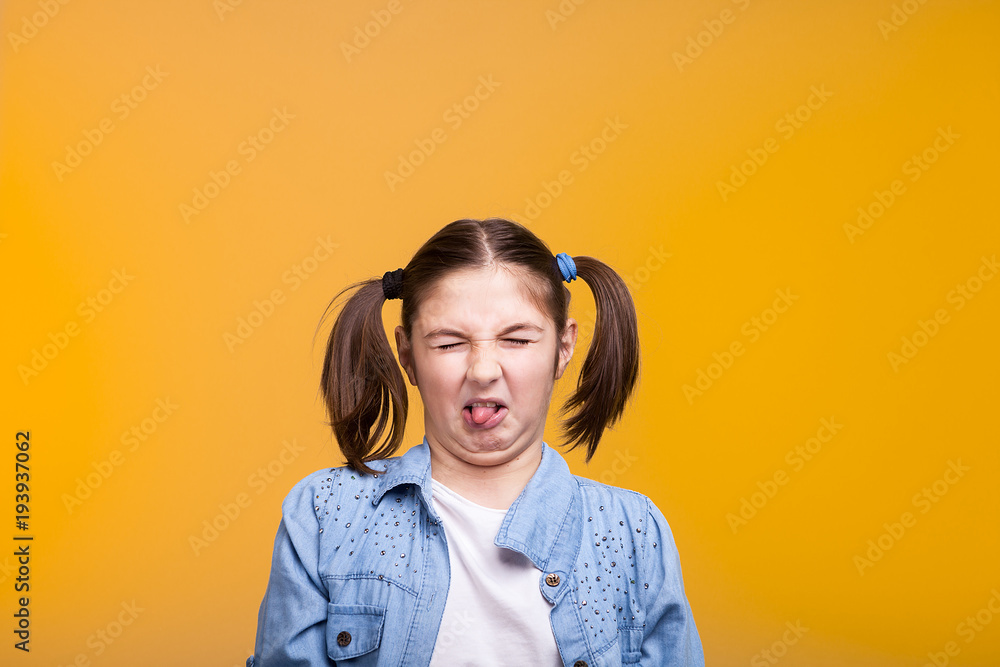Ταπετσαρία Girl in studio making a disgusted face with eyes closed on yellow background